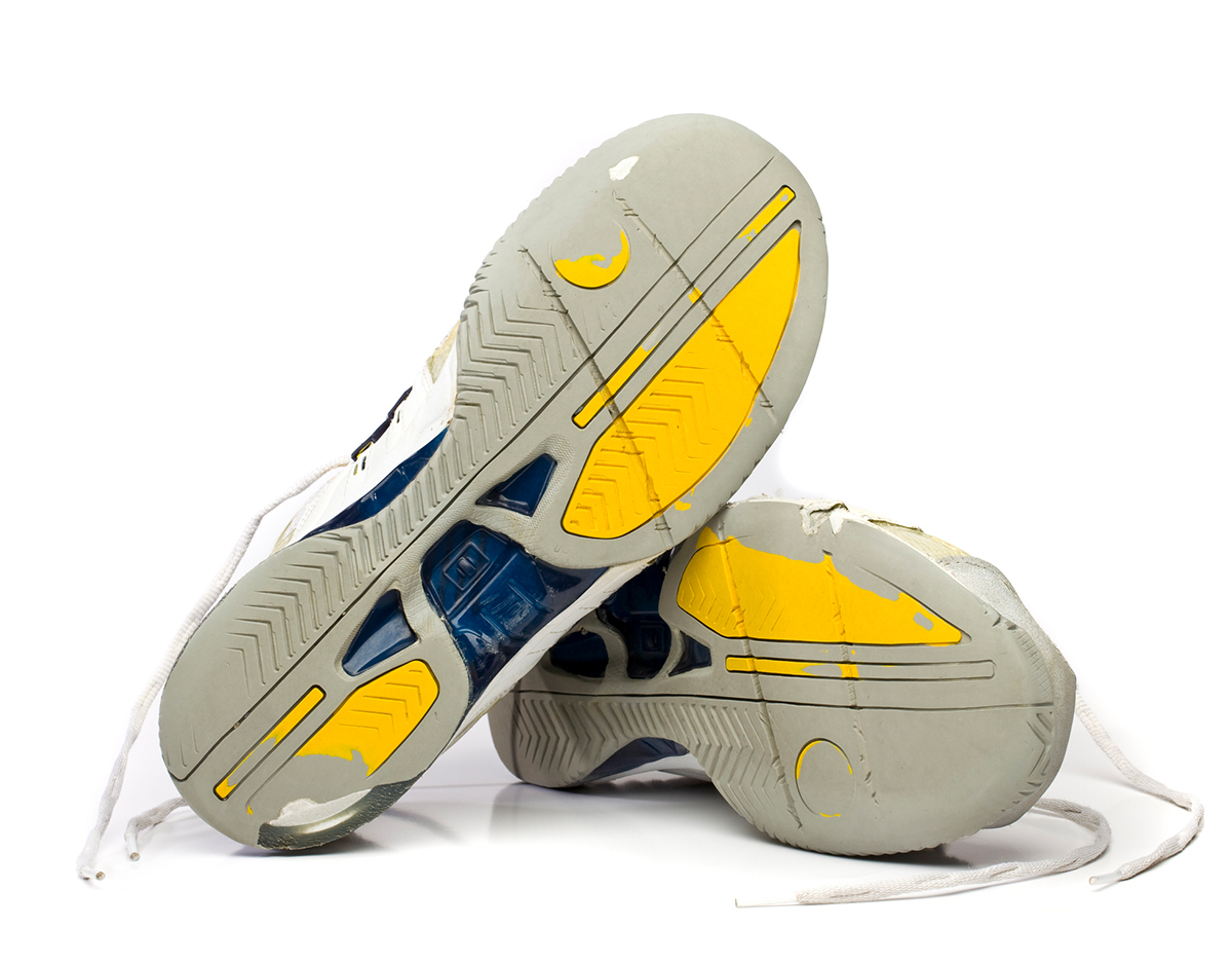 Worn running shoes isolated on white.